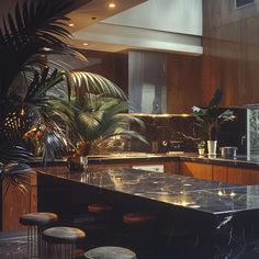 a kitchen with marble counter tops and stools next to a plant in the corner