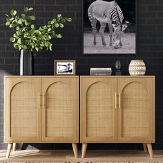 a zebra standing in front of a black brick wall next to a wooden sideboard