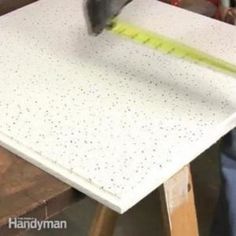 a man is measuring the top of a table