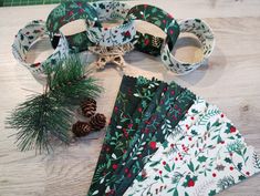 several christmas napkins and pine cones on a table