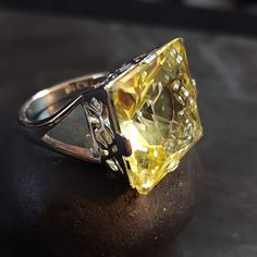 Stainless Steel ring with a split ring band and large 18mm pale yellow cubic zirconia (CZ) stone. ◄ FEATURES ► * Silver ring size 7 * Metal stamp says TK316 (steel) * Statement ring. High quality. Lots of sparkle. * The Topaz/Citrine CZ is 18mm. * The front of the ring is 10 tall. * The ring band is 2.5mm wide at the back. For size reference: * a U.S. penny is 19.05mm diameter.  * a U.S. nickel is 21.21mm diameter.  * a U.S. quarter is 24.26mm diameter.  ◄ HOW TO CARE FOR CZ JEWELRY ► 1. Keep it clean. Clean your CZ jewelry regularly to maintain its luster and shine. Use a soft-bristled brush or a soft cloth to gently wipe away dirt, dust and grime. 2. Store it safely. When not in use, store your CZ jewelry in a safe place, such as a jewelry box or a cloth pouch. Keep it away from other je Formal Yellow Topaz Ring With Diamond Accents, Elegant Yellow Topaz Ring With Round Cut, Elegant Yellow Topaz Ring Round Cut, Elegant Yellow Round Cut Topaz Ring, Yellow Rings With Diamond Accents For Promise, Yellow Diamond Ring With Gemstone, Yellow Diamond Rings With Gemstone, Yellow Topaz Ring With Diamond Center Stone, Elegant Yellow Diamond Ring Hallmarked