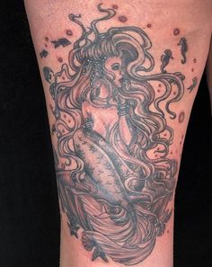 a woman's leg with an octopus tattoo on it