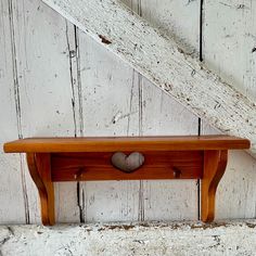 an old wooden shelf with a heart on it