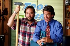 two men in shirts and ties are holding up hammers while standing next to each other