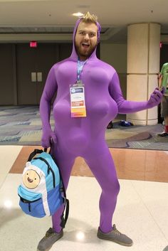 a man in a purple costume is holding a backpack