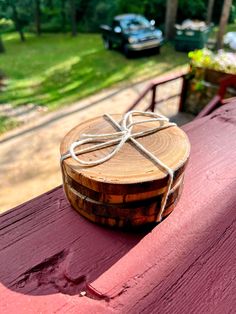 a piece of wood with a bow tied to it sitting on top of a red bench