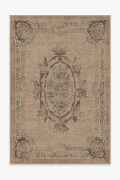 a beige rug with an ornate design on it