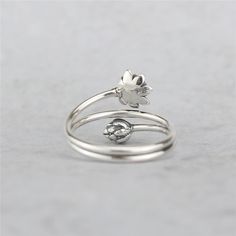 Gorgeous, one-of-a-kind lotus ring Made of 100% real 925 sterling silver Reminding you to be mindful Attract all good things Ring size adjustable / Surface width: 14mm (0.55in) Limited - NOT available in stores Worldwide Shipping Available & 100% Money-Back Guarantee Lotus is symbolic of purity of the body, speech, and mind as while rooted in the mud, its flowers blossom on long stalks as if floating above the muddy waters of attachment and desire. It is also symbolic of detachment as drops of w Spiritual Silver Adjustable Flower Ring, Adjustable Silver Spiritual Flower Ring, Adjustable Spiritual Silver Flower Ring, Adjustable Silver Flower Ring, Adjustable Open Flower Ring In White Gold, Adjustable White Gold Flower Open Ring, Adjustable White Gold Open Flower Ring, Delicate Adjustable Silver Flower Ring, Vintage Lotus Flower