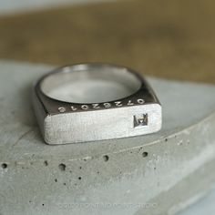 a close up of a ring with a diamond on it's center stone surface