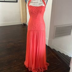 an orange dress on display in a room