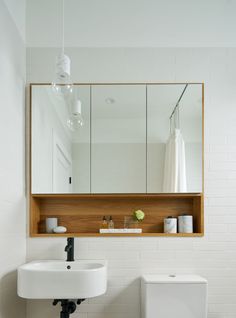 a bathroom with a sink, mirror and toilet