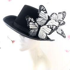 Top hat with monarch butterflies, butterfly hat, black steampunk hat with butterflies From our Whimsical Collection, this elegant women's hoop hat features monarch butterflies on a black fascinator base. Pictured are black and white monarch butterflies; you have the option to pick others butterfly colors as well I N C L U D E D Butterflies on clip attached to the hat and is removable. In secure box packaging to keep form. S H I P P I N G - Processed same day or within 24 hours. 1-2 day guarantee Red Mask Masquerade, White Top Hat, Butterfly Colors, Elegant Face Mask, Butterfly Hat, Black Steampunk, Steampunk Top, Steampunk Top Hat, Black Fascinator