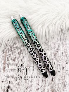 two pens sitting on top of a white fur covered floor next to an animal print pen