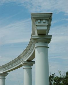 a clock on top of two white pillars