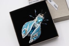 Buy an exclusive gift for your loved one - Beaded brooch Blue Insect! Perfect as Unique statement gift for anniversary, teacher's appreciation gift, Nature lover gift, birthday gift, Christmas gift. The Blue Bug brooch is handmade. The wings are movable. They can be positioned in different positions at your discretion. The Embroidered insect will be well combined with an evening dress, a woman jacket -lapel pin, Jean demin jacket, business suit, warm sweater or scarf as shawl brooch, making a fi Handmade Blue Brooches For Gift, Shawl Brooch, Brooch Making, Bug Brooch, Demin Jacket, Wedding Brooch, Warm Sweater, Beaded Brooch, Brooches Handmade