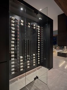 a wine cellar with glass walls and lots of bottles