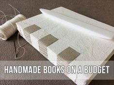 there is a white object on the floor next to some yarn and scissors with text overlay that reads handmade books on a budget