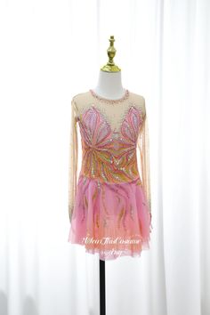 a pink and gold dress on a mannequin