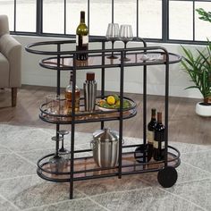 a bar cart with bottles and glasses on it