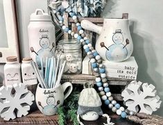 an assortment of items displayed on a table with snowflakes and other holiday decorations