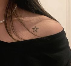 a woman with a small star tattoo on her shoulder