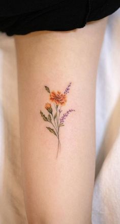 a small flower tattoo on the leg