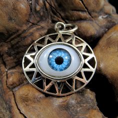 Handcrafted Solid 925 Sterling Silver All Seeing Eyeball w/Rays Pendant NOW: Choose between BLUE or BROWN eyeball! This is a funny take on the all seeing eye; instead of the classical eye of ra, this goofier version features a plastic craft eyeball surrounded by rays set in a solid sterling silver pendant. It's bound to spark a conversation wherever you go! We have added a brown eye as an option in the listing for more variety! I have included a photograph of the pendant next to a quarter for si Blue Engraved Amulet Style Jewelry, Blue Engraved Amulet Jewelry, Blue Sterling Silver Amulet Jewelry, Symbolic Blue Engraved Jewelry, Unique Silver Evil Eye Jewelry, Symbolic Blue Round Jewelry, Unique Sterling Silver Evil Eye Jewelry, Symbolic Eye-shaped Silver Jewelry, Spiritual Eye-shaped Sterling Silver Jewelry