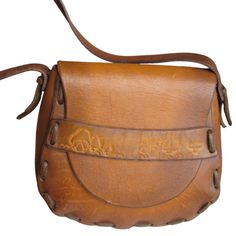 Fabulous Hippie Hobo Shoulder Bag In Saddle Leather With Flap Closure And Embossed Mushroom Accent. Very Clean, Appears To Be Unused. Melon Or Mandolin Shaped Strap Drop 13" Length 7" Depth 4.5" Width 9.5" Hand Stitched In The Usa Retro Leather Saddle Bag, Retro Hand-tooled Bags, Retro Leather Saddle Bag For Daily Use, Vintage Satchel Saddle Bag In Soft Leather, Vintage Saddle Shoulder Bag With Adjustable Strap, Vintage Soft Leather Saddle Satchel Bag, Vintage Soft Leather Satchel Saddle Bag, Vintage Soft Leather Saddle Bag, Vintage Soft Leather Saddle Bag For Daily Use