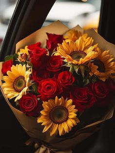 a bouquet of sunflowers and roses in a car