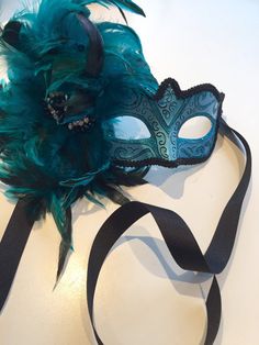 Masks Turquoise mask- feather Masquerade Mask- Mardi Gras Masquerade Mask- Holiday Mask- Halloween -Masked ball -Masquerade party mask Hello, This feather mask is a stunning stopper and is made with turquoise coque feathers are about to 8 inch. They fan out and are placed on a beautiful Blue Costume Accessories For Carnival, Blue Costume Accessories For Carnival Party, Green Masks And Prosthetics For Carnival Costume Party, Green Masks For Masquerade Carnival, Green Mask For Masquerade Carnival, Green Masquerade Mask For Mardi Gras Party, Green Masks For Carnival Masquerade, Green Masks For Carnival Costume Party, Blue Masks And Prosthetics For Carnival Party