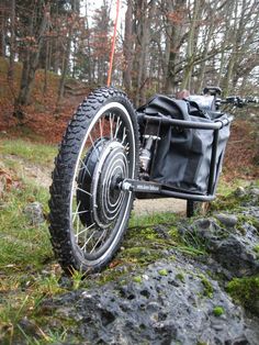 an old motorcycle is parked on some rocks