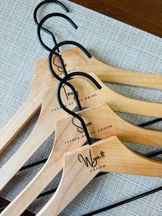 four pairs of glasses sitting on top of a wooden rack with black wire and wood handles