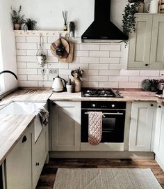 a kitchen with white cabinets and wooden floors