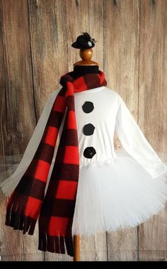 a dress made to look like a snowman with a red and black plaid scarf