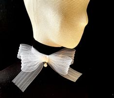 Flower bow choker is a trendy and chic accessory that adds a touch of elegance to any outfit. It can be worn with formal attire to enhance an elegant evening look or paired with casual outfits to add a touch of sophistication. Whether dressing up for a special event wedding, party..) or looking to elevate everyday wear, the organza choker with a bow offers a charming and eye-catching detail to complete the ensemble. Materials: velvet / organza Velvet choker: width: 20mm / 0.8 inches. Size: 29-36cm/ 11-14 inches adjustable length.  Closure: adjustable clasp Bow Size: 170x170mm / 7x7 inches.  Color: available in more colors  *Custom colors or sizing welcome - please message me prior to ordering. *Optional: matching bracelet, hair accessories, please write to create a unique set suitable for Elegant Bow For Gift In Spring, Elegant Satin Bow For Spring, Chic White Bow For Party, White Spring Party Bow Tie, White Bow For Spring Party, Elegant Spring Wedding Bow Tie, Elegant Spring Bow Tie With Butterfly Knot, Formal White Bow With Butterfly Knot, Elegant Bow Tie For Spring Gifts