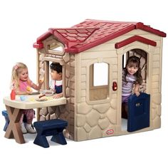 three children are playing in a play house