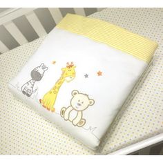 a baby crib with a yellow and white blanket