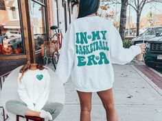 Celebrate your passion for basketball with this stylish and comfortable sweatshirt. The phrase 'In My Basketball Era' boldly adorns this garment, symbolizing the dedication, skill, and love for the game. 🔥 Made with cozy fabric, this sweatshirt offers both style and comfort on and off the court. Whether you're shooting hoops, practicing drills, or simply lounging after a game, this sweatshirt is the perfect companion for every basketball enthusiast. 🎁 Looking for the perfect gift for a basketball player, coach, or someone who lives and breathes the game? Our 'In My Basketball Era' sweatshirt is an ideal choice to celebrate their love for the sport and dedication to the game. 🏆🌈 Available in various sizes and colors to match individual tastes, this sweatshirt is a thoughtful and stylish Softball Sweatshirt, Volleyball Coach Gifts, Volleyball Sweatshirts, Dance Sweatshirt, Gymnastics Mom, Girls Basketball, Cheerleading Gifts, Cheer Coaches, Coaching Volleyball