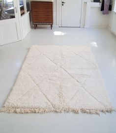 a large white rug in the middle of a room