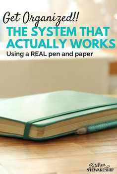 an open book with the title get organized the system that actually works using a real pen and paper