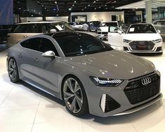 an audi car is on display at the showroom with other cars in the background