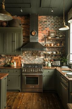 a kitchen with green cabinets and brick walls, wood flooring and an oven in the center