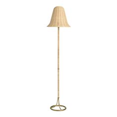 a floor lamp with a beige shade on it