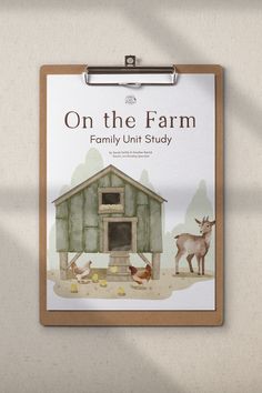 a clipboard hanging on the wall with an image of farm animals and a barn