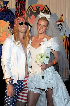 two people dressed up in costumes posing for a photo with one person wearing an american flag costume