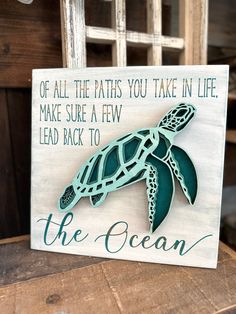 a wooden sign with a sea turtle on it