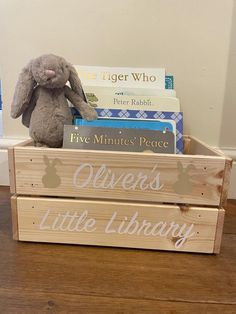 a wooden crate filled with books and a stuffed animal