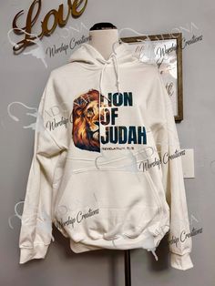 the lion of judah hoodie is on display in front of a sign that says love