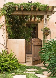 an entrance to a house with lots of greenery