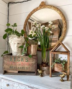 there is a mirror and some flowers on top of a dresser with the words love this feature